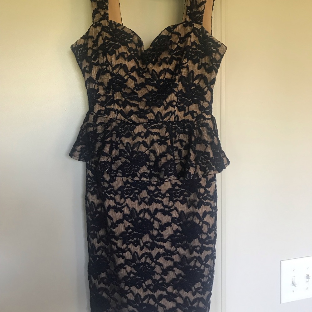 B. Smart nude peplum dress with navy overlay